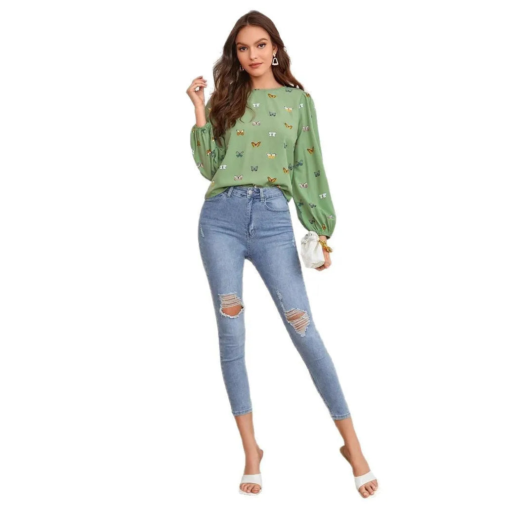 Women's butterfly print long-sleeved shirt in green colour showing loose fit and regular sleeves