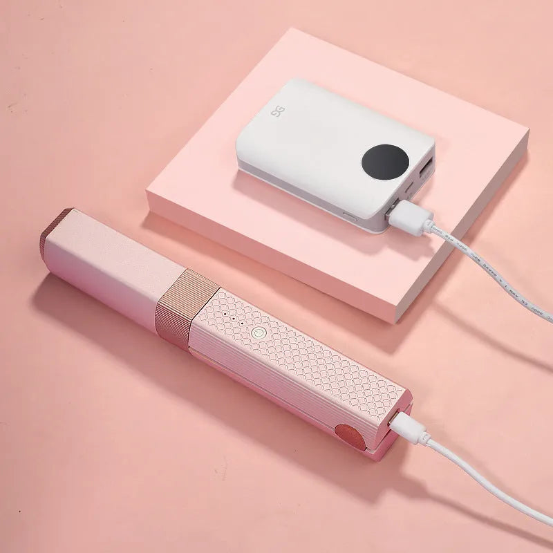 Pink and green cordless USB hair straightener with ceramic plates, shown with USB cable.