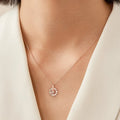 Rotatable S925 silver snowflake necklace for women with rhinestone detail, available in rose gold or white gold.