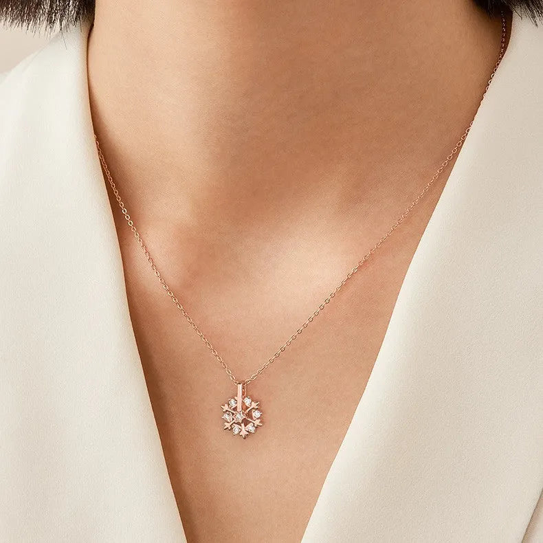 Rotatable S925 silver snowflake necklace for women with rhinestone detail, available in rose gold or white gold.