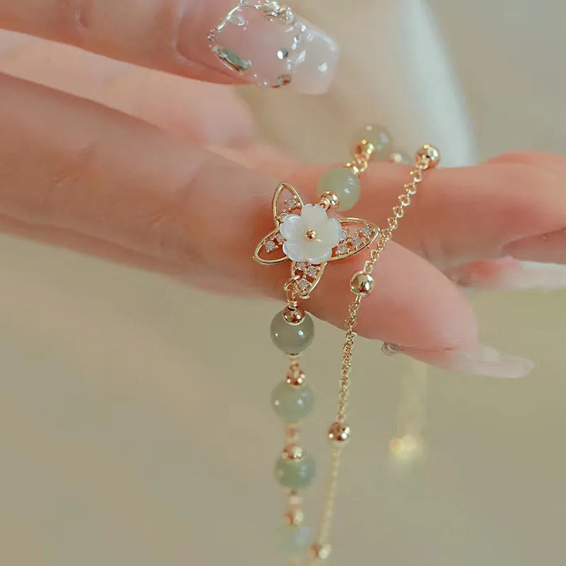 Yellow gold electroplated copper bracelet with butterfly charm and geometric shape for women.
