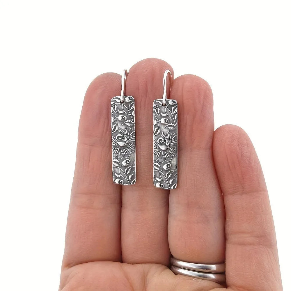 Silver geometric long earrings with carved vine detailing measuring 20 cm