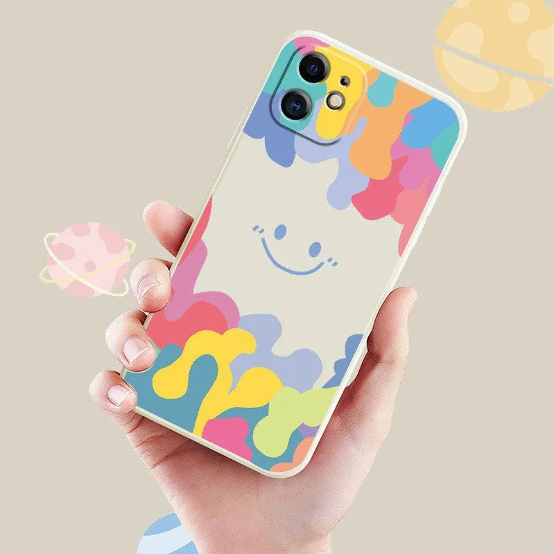 White TPU phone case with rainbow smiley face design and attached black lanyard for Apple iPhone.