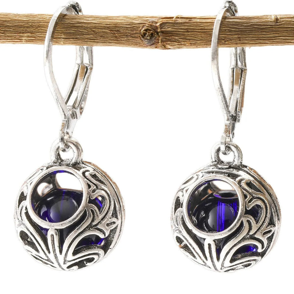Silver geometric pendant earrings with vintage engraving and hollow design around blue gemstone
