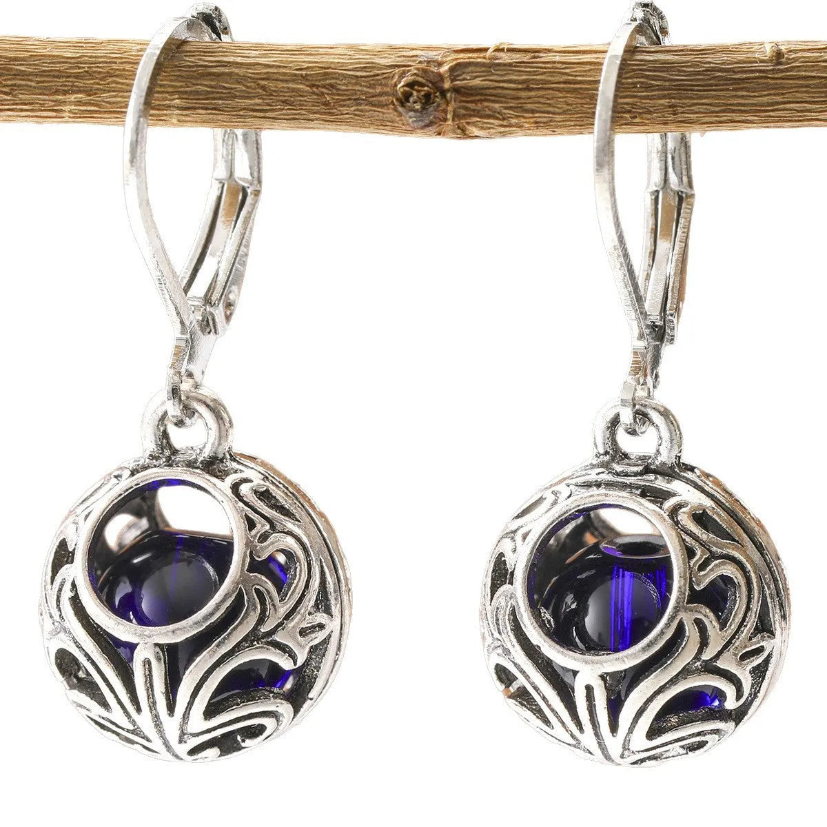 Silver geometric pendant earrings with vintage engraving and hollow design around blue gemstone