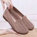 Beige low-top mesh tennis shoes for women with wide feet, showing breathable upper and flat PVC sole.