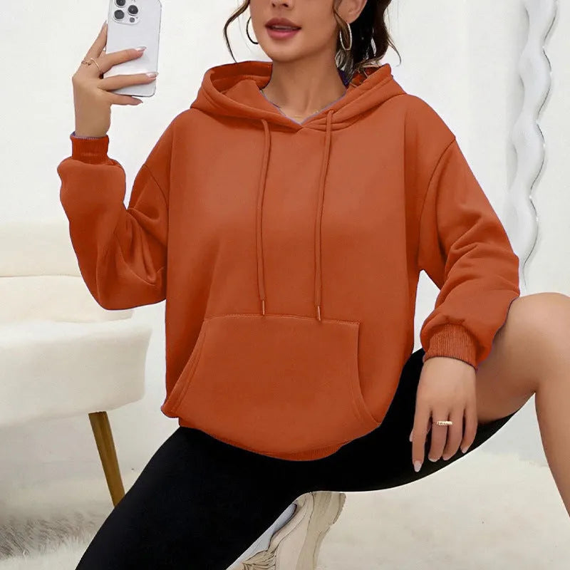 Women's loose grey sweatshirt with long sleeves and a front drawstring pocket, shown in a relaxed fit.