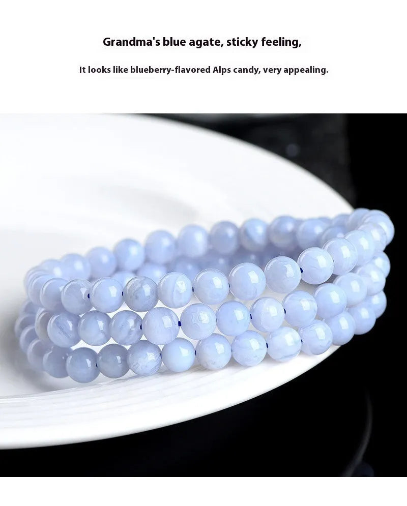 Blue agate bracelet with 6-6.8mm beads showing multi-circle pattern and scattered striped agate beads, Ruyi elements visible