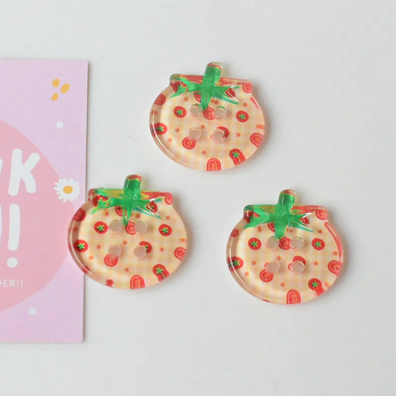 Medium size red tomato pattern button ornaments made from plastic resin, shown in different colour variations.
