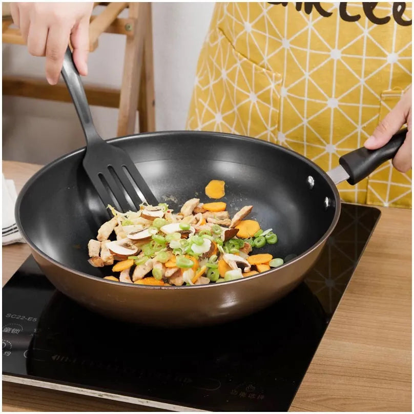 Cast iron three-piece cookware set with soup pot, milk pot, and wok on a kitchen counter