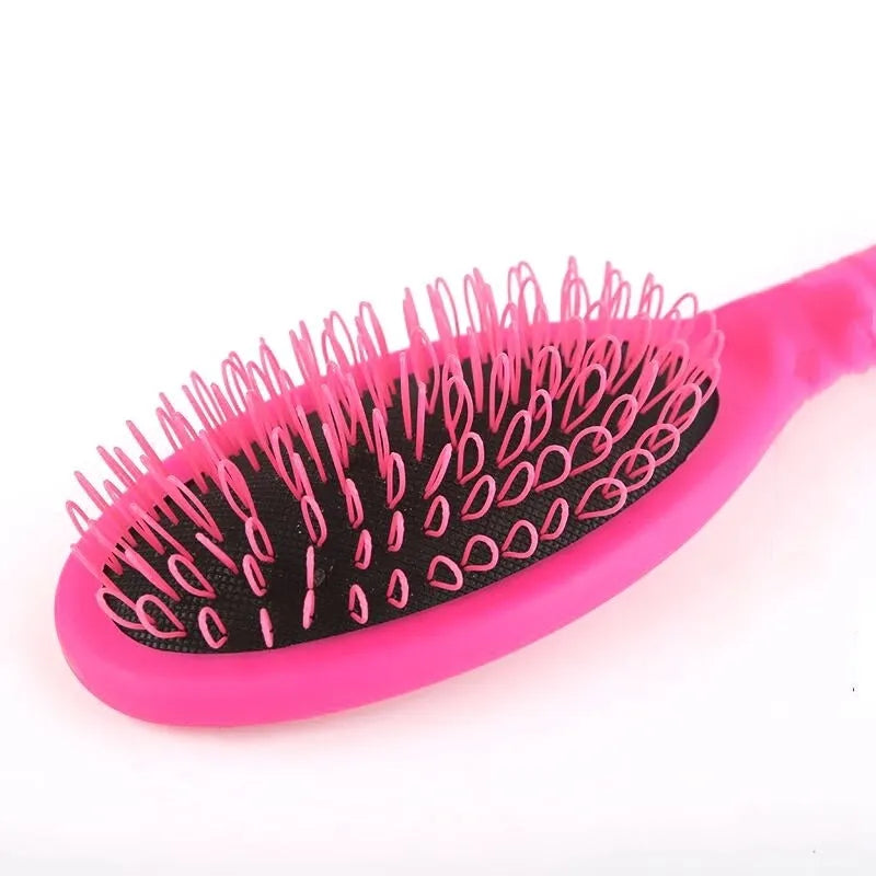 Black and pink ring tooth airbag comb for hair extensions on a white background