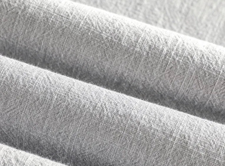 Men's loose fit linen shirt in solid colour with natural fabric texture, showing relaxed sleeve and collar design