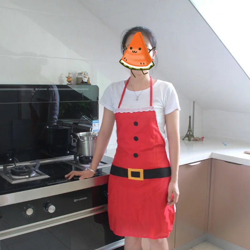 Red Christmas apron for adults and children on a hanger, showing adjustable neck and waist straps.