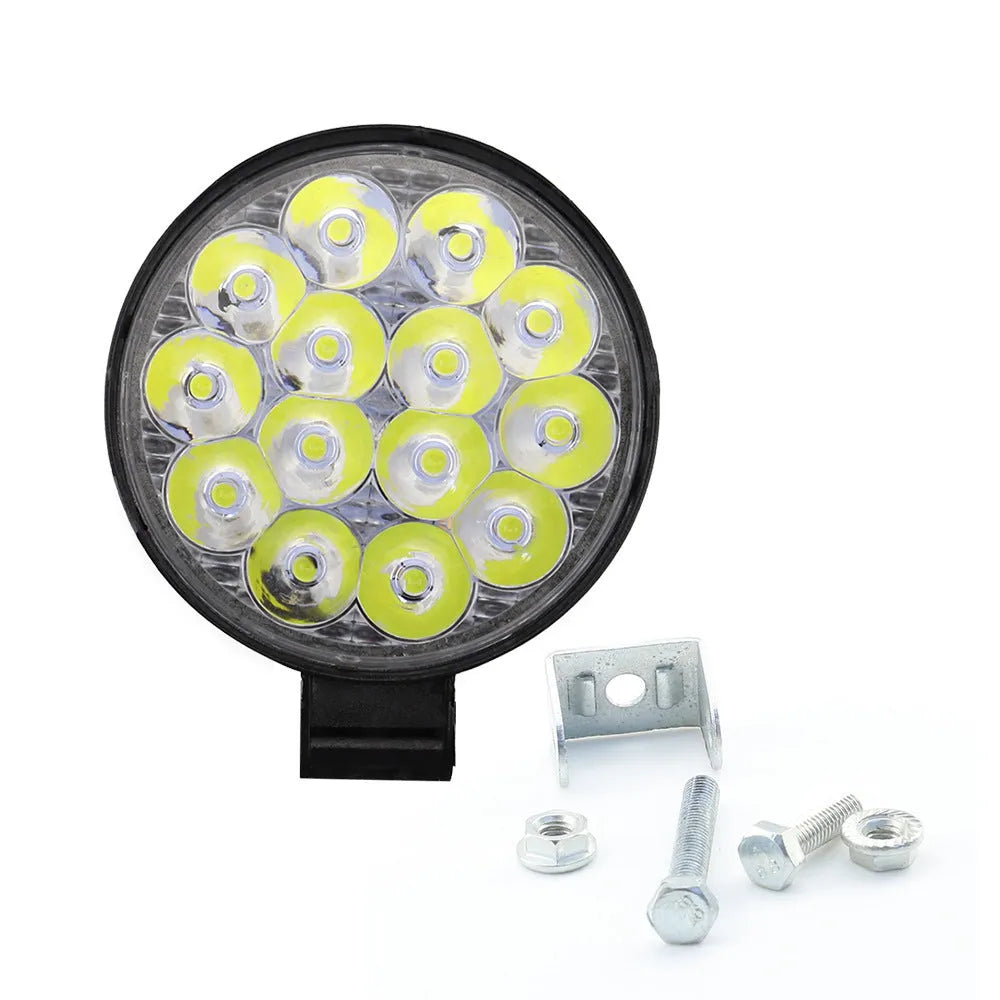 White mini round aluminium LED work light with IP67 rating for vehicle use.