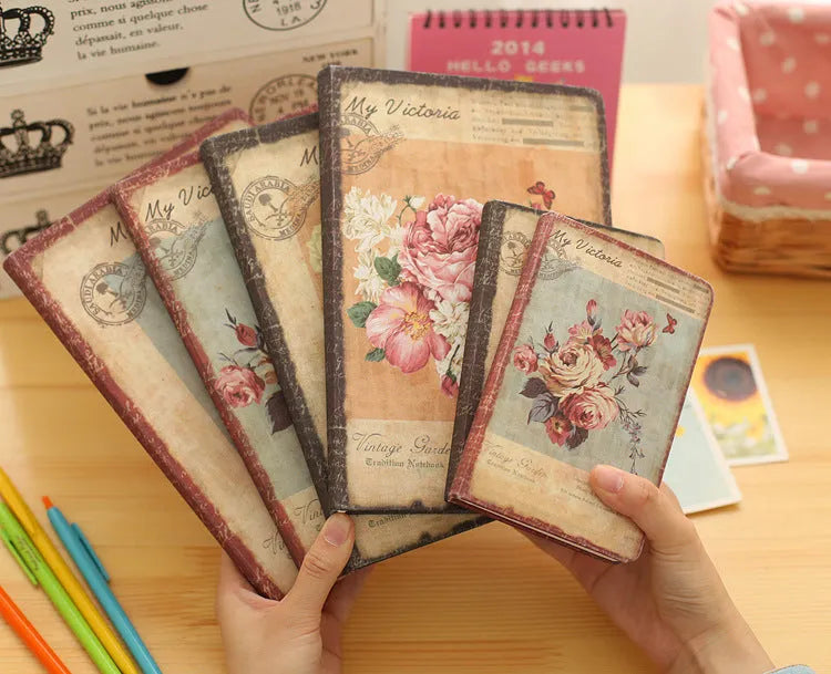 Hardcover notebook with cloth cover showing retro floral pattern in either lily, peony or white rose design