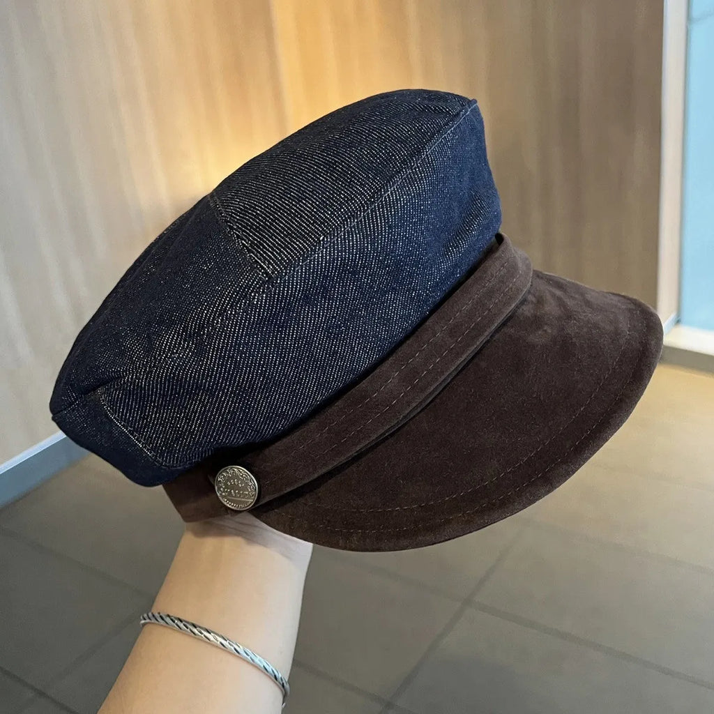 Dark blue denim British retro octagonal newsboy cap with an adjustable strap and coloured brim option on display.