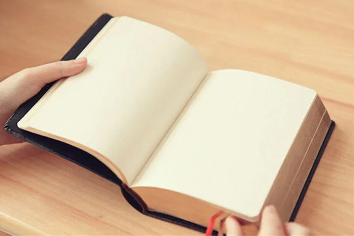 Large thick leather notebook 17 x 12 cm with 480 pages and gold or white cover.