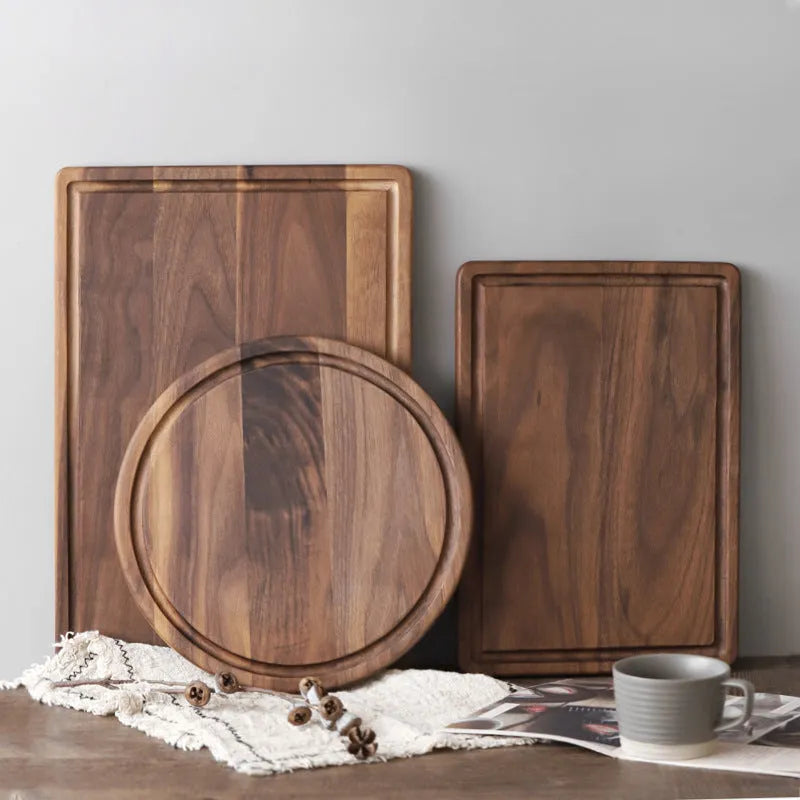 Black walnut wood cutting board with sauce groove and side handle in round and rectangular sizes