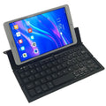 Mini folding ultra-thin wireless Bluetooth keyboard in black or white for tablets and smartphones.