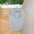 Blue coral fleece pet jacket for a dog, showing the coloured pull ring fastening.