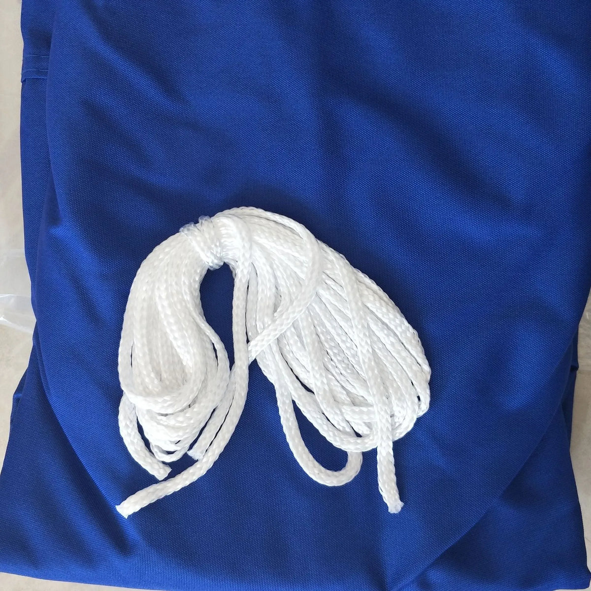 Blue waterproof polyester shade sail measuring 3x4 metres in a curved square shape.