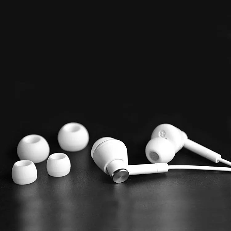 Black and white wired in-ear earphones with 3.5mm connector for mobile phones and computers