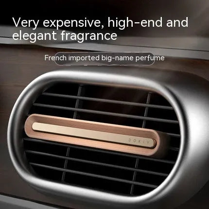 Long strip car aromatherapy ornament in walnut colour mounted on a car air vent