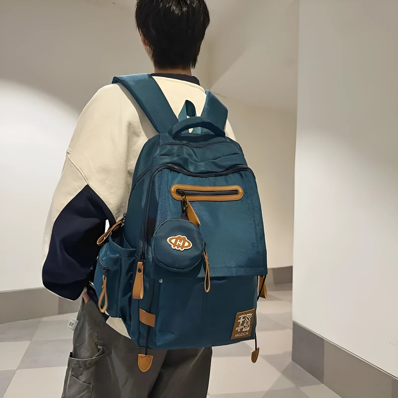 Large nylon school backpack in a solid colour with curved shoulder straps, shown from a side angle.