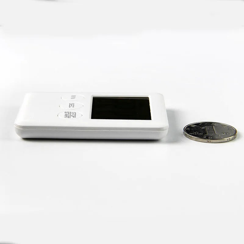 Black and white kitchen timer with magnetic back showing dial interface for 60-minute timing