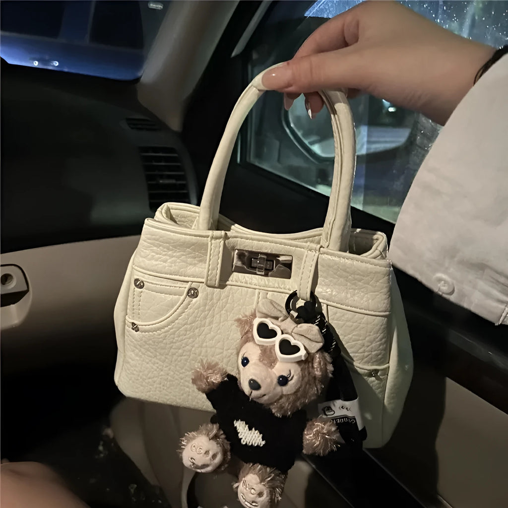 Women's casual shoulder bag in denim blue or white colour made from soft PU material