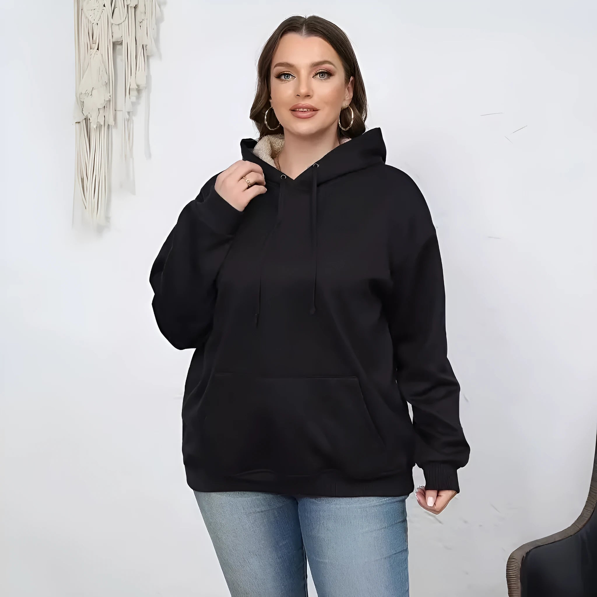 Women's black hooded sweater with a textured 3D pattern, loose fit, and front pockets.