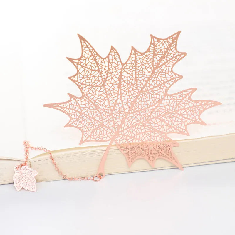 Metal bookmark with hollow plating pattern and rose gold tassel in maple leaf pendant design