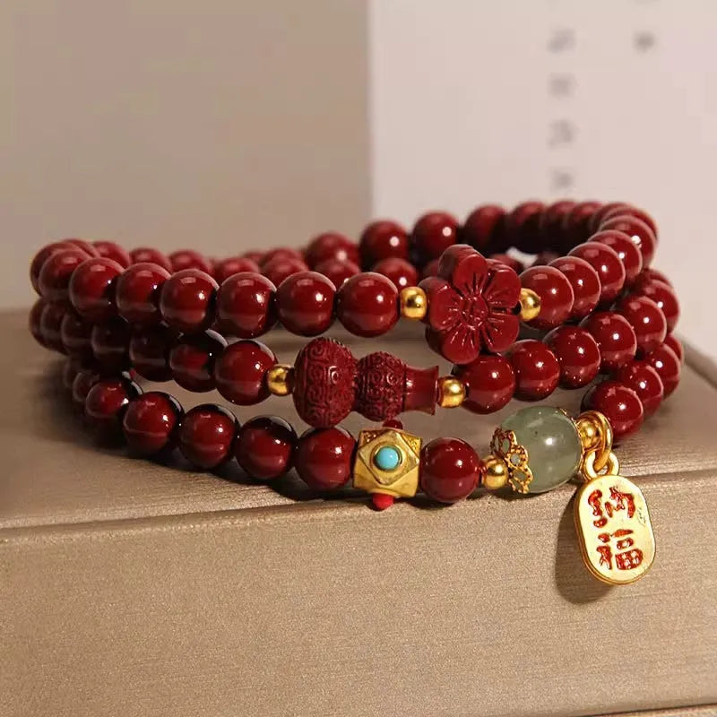 Red cinnabar bracelet with geometric gourd and flower design, 6mm diameter with clasp fastening