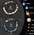 Two natural stone beaded bracelets with zodiac sign charms on a wooden surface.