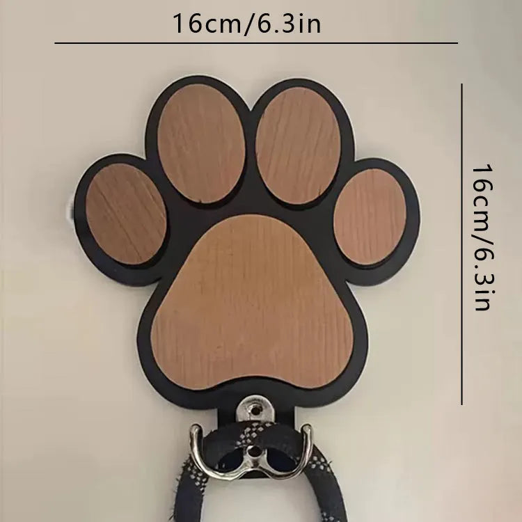 Black wooden wall hook shaped like a paw print for hanging coats and keys
