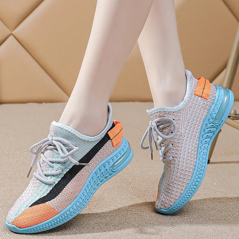Women's low-top running shoes in purple, featuring a rounded toe and front lace-up design.