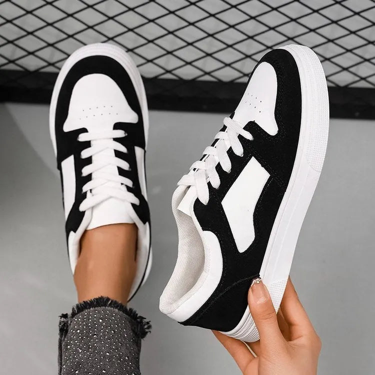Black women's casual sports shoes with artificial PU upper and rubber sole, showing round toe and lace-up design