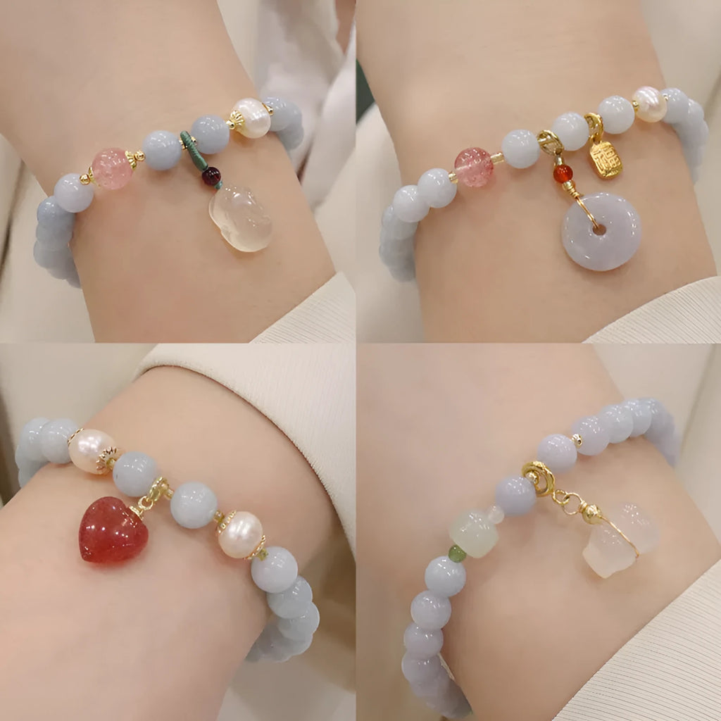 Women's gold plated crystal bracelet with aquamarine chalcedony charm on wrist