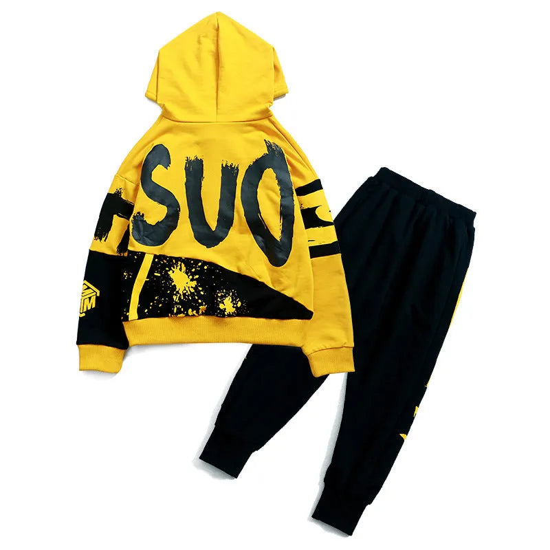 Boy's black and yellow hooded cotton sports suit trousers set on hanger, showing Korean style letter pattern.