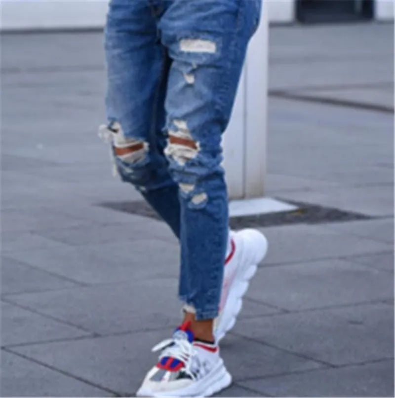 Men's deep blue cotton jeans showing the five-pocket design on a neutral background.