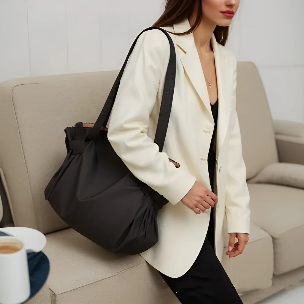 Women's black crossbody shoulder bag made from Oxford cloth with a large expandable storage compartment.