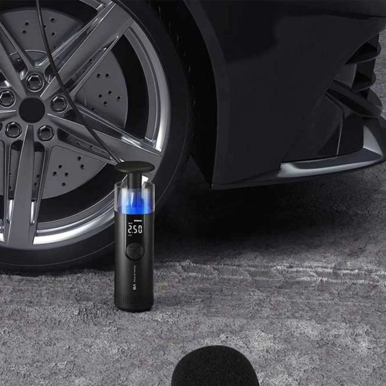 Electric high-pressure tyre inflator pump with digital display, long black hose, and tyre pressure gauge on a grey background