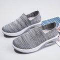 Women's mesh running shoes with air cushion technology in beige colour showing round toe shape and casual design