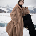 Loose plus size long leopard print faux fur coat in brown leopard print, showing 100cm length and regular sleeves.