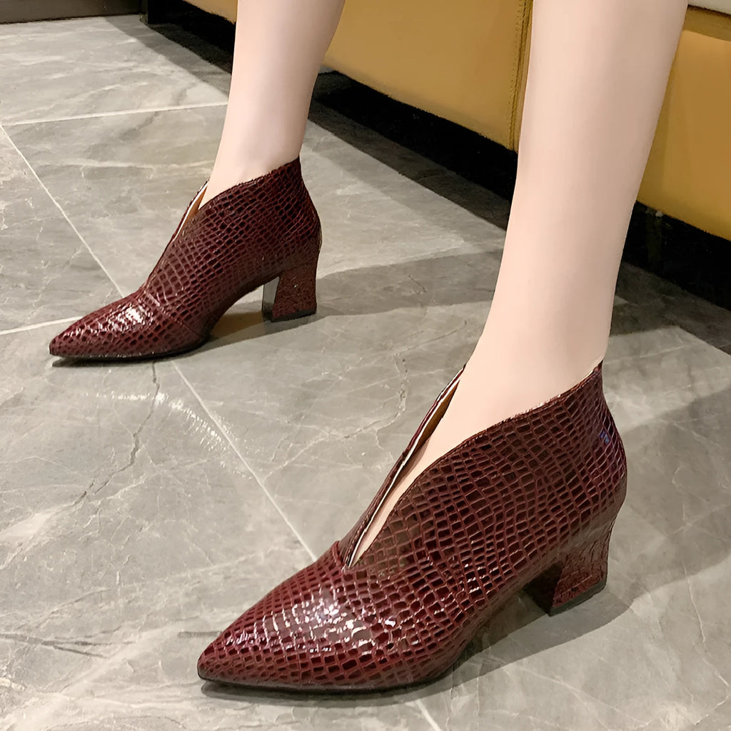 Women's V-cut ankle boots with pointed toe and embossed PU upper in black colour with chunky heel