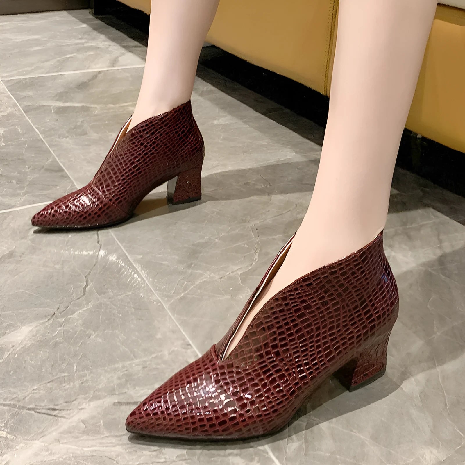 Women's V-cut ankle boots with pointed toe and embossed PU upper in black colour with chunky heel