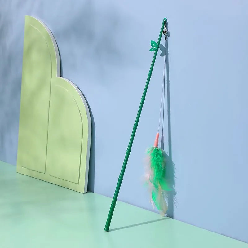 Green interactive cat wand toy with feather and bell attachments for stimulating play
