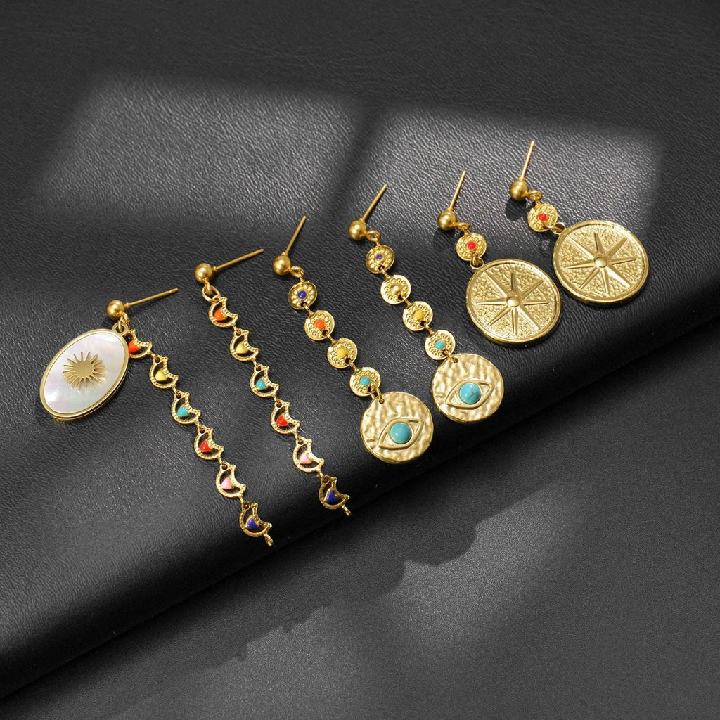 Three pairs of geometric stainless steel earrings showing Eight Awn Star, Eye, and Shell Sun designs.