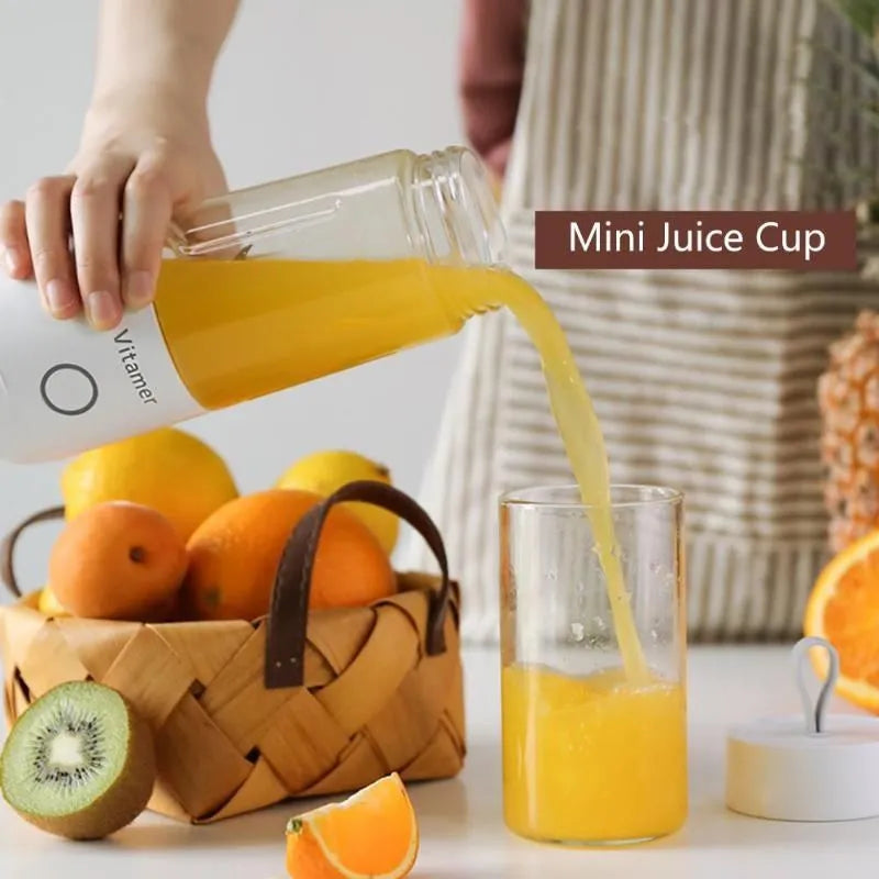 White portable USB rechargeable blender with 350ml cup and silicone handle on a table.