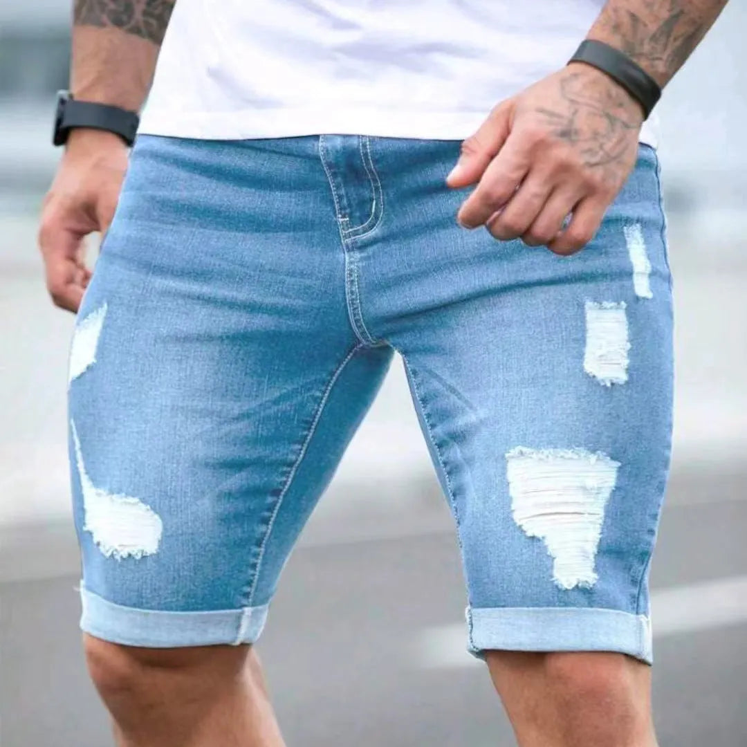 Sky blue men's denim shorts with manual distressing and multi-hole detailing on straight-leg cut